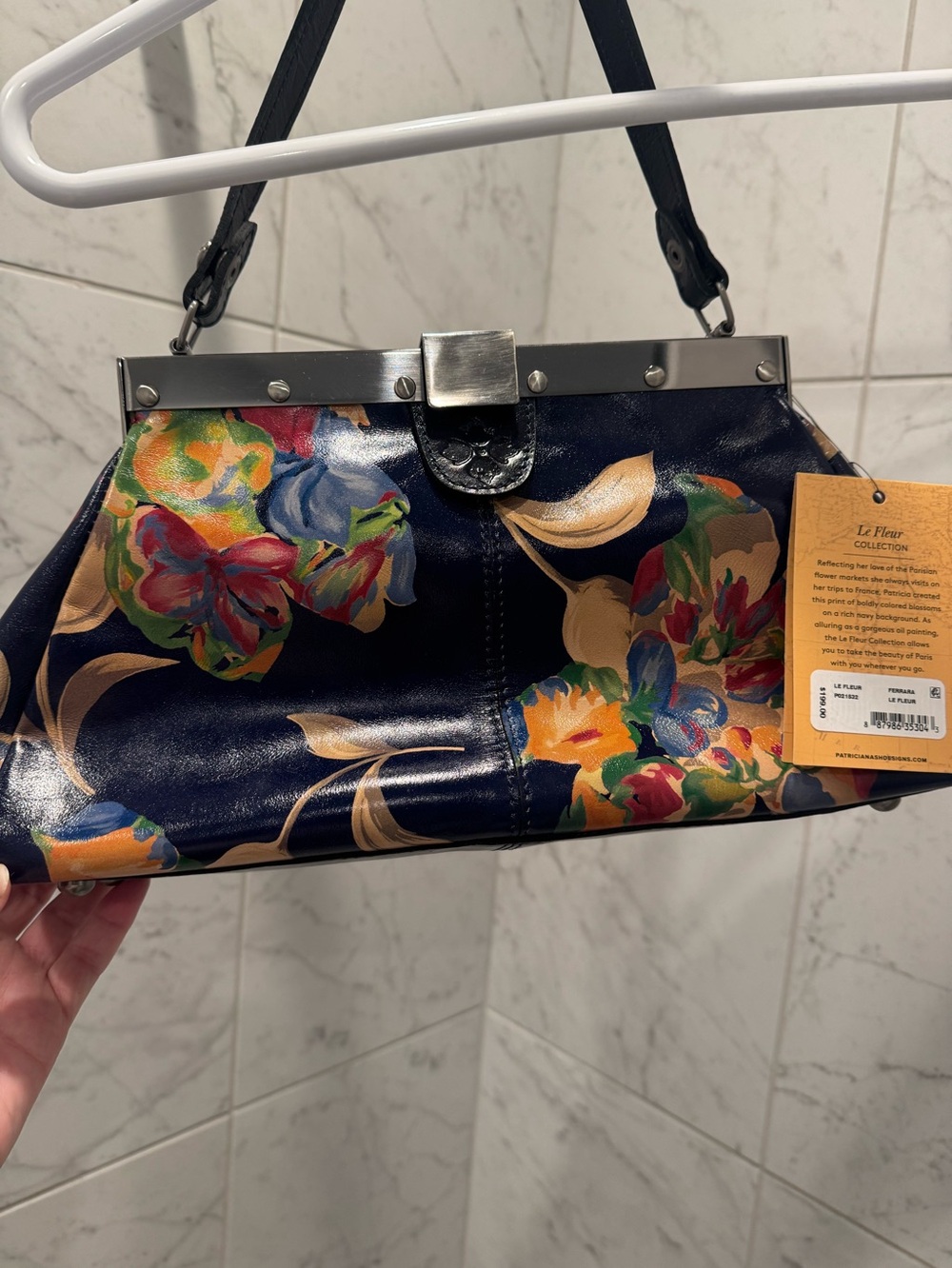 Patricia Nash 
Le Fleur Navy Floral Frame Clutch with Shoulder Strap